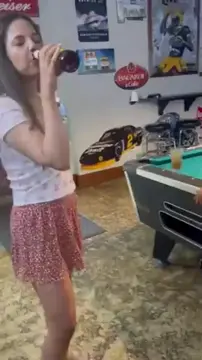 Nympho shoves beer bottle in her cunt in public bar